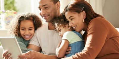 Family,Comes,First.,Shot,Of,A,Young,Family,Using,A